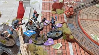 Fallout Factions miniatures huddled together, surrounded by tokens